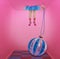 Women`s legs in pink socks above Christmas blue ball on a pink Christmas background