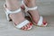 Women\'s legs and white sandals