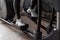 Women`s legs in white sneakers working on the stepper simulator in the gym. Girl doing exercises in a health club. Close-up