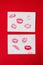 Women`s lips lipstick kiss print set for Valentine`s Day and love collection on white paper on red . The shape of the lip makeup