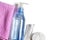 Women`s makeup remover accessories. Gel in a transparent bottle, cotton buds, cotton pads, pink towel