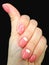 Women& x27;s manicure. The shape is a soft square, pale pink color with a smile at the cuticle. Female fingers