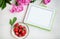 Women`s office workplace with strawberries and flowers. Mockup with digital Tablet PC