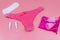 Women`s panties with menstrual cups, sanitary pads and tampons on pastel pink background