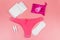 Women`s panties with menstrual cups, sanitary pads and tampons on pastel pink background. Top view