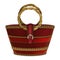 Women`s red handbag with a round bamboo handle decorated with a buckle