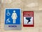 The women`s restroom and tornado shelter signs directing people to the shelter