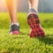 Women\'s running legs, pink-gray sports shoe detail
