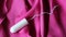 Women`s sanitary tampon on a pink dress, hygiene products