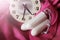 Women`s sanitary tampons and clock on a pink dress, hygiene products