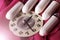 Women`s sanitary tampons and clock on a pink dress, hygiene products
