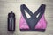 Women`s sports bra and Black Bicycle water bottle. Sport accessories and fashion.