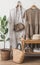 Women\\\'s summer clothes, oak bench, ficus flower in a basket in the bedroom interior in Scandinavian style