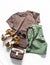 Women`s summer clothing walking set - brown t-shirt, cotton green shorts, suede sandals, leather cross body bag on a light