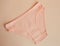 Women`s underwear. pink underpants on a light background. a piece of clothing for a person.