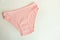 Women`s underwear. pink underpants on a light background. a piece of clothing for a person.