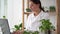 Women scientist working on a laptop computer, making analysis of a lab-grown food. Microbiologist working in modern