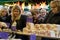 Women Shoppers Browsing at a Christmas Market Stand.