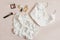 Women silk lingerie on beige background top view, flatlay. Female lace nightwear clothes