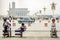 women sit at the Tiananmen place in china with very low traffic