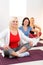 Women sitting cross-legged on mat