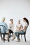 Women sitting together during psychotherapy with senior counselor