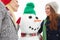 Women, snow and snowman with Christmas selfie and holiday, winter break in Canada with festive spirit and tradition with
