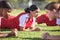 Women soccer players in a team doing the plank fitness exercise in training together on a practice sports field. Healthy