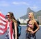 Women sport fans holding USA Flag in Rio de Janeiro with Christ the Redeemer in background.