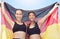 Women, sports team and German winner flag in exercise, workout or training competition success. Portrait, happy smile or