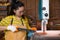 Women standing is craft working cut wood at a work bench with band saws power tools at carpenter machine in the workshop