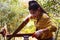 Women standing is craft working cut wood at a work bench with circular saws power tools at carpenter machine