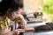 Women standing is craft working cut wood at a work bench with circular saws power tools at carpenter machine