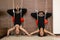 Women standing upside down practicing yoga on ropes stretching in gym. Fit and wellness lifestyle