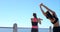 Women, stretching body in beach and exercise for fitness, wellness and cardio training in city. Athletes, warm up and