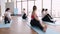 Women stretching their bodies in a gym with a fitness instructor