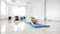 Women students working out their flexibility on a mat during a yoga class in slow motion -