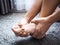 Women suffering from acute foot pain and use hands to massage on feet.