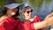 Women in summer outfits taking selfie photo on sailing boat