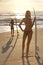 Women Surfers In Bikini & Surfboards Sunset Beach