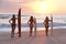 Women Surfers With Surfboards At Sunset