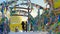 Women take photos with prayer flags hanging in wind at temple complex in winter