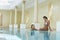 Women Talking At Edge Of Swimming Pool