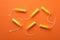 Women tampons on orange background, top view