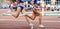 women team running relay race in track stadium summer athletics