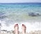 Women toes in the sea foam on the beach