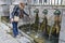 Women is touching the hot water jet from the thermal source in the center of Dax city. Southwestern France, Landes, Nouvelle