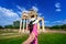 Women tourists holding man`s hand and leading him to Aphrodisias ancient city in Turkey.