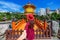 Women tourists holding man`s hand and leading him to Golden Pavilion in Nan Lian Garden near Chi Lin Nunnery temple, Hong Kong