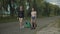 Women tourists with travel bags walk on rural road